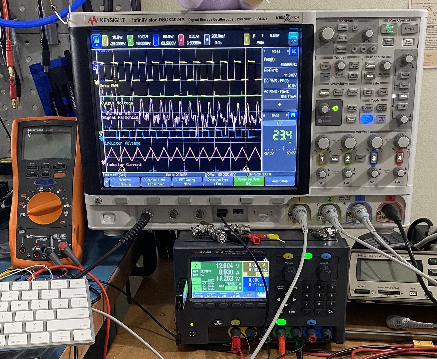 Electronics testing laboratory with oscilloscope and multimeter